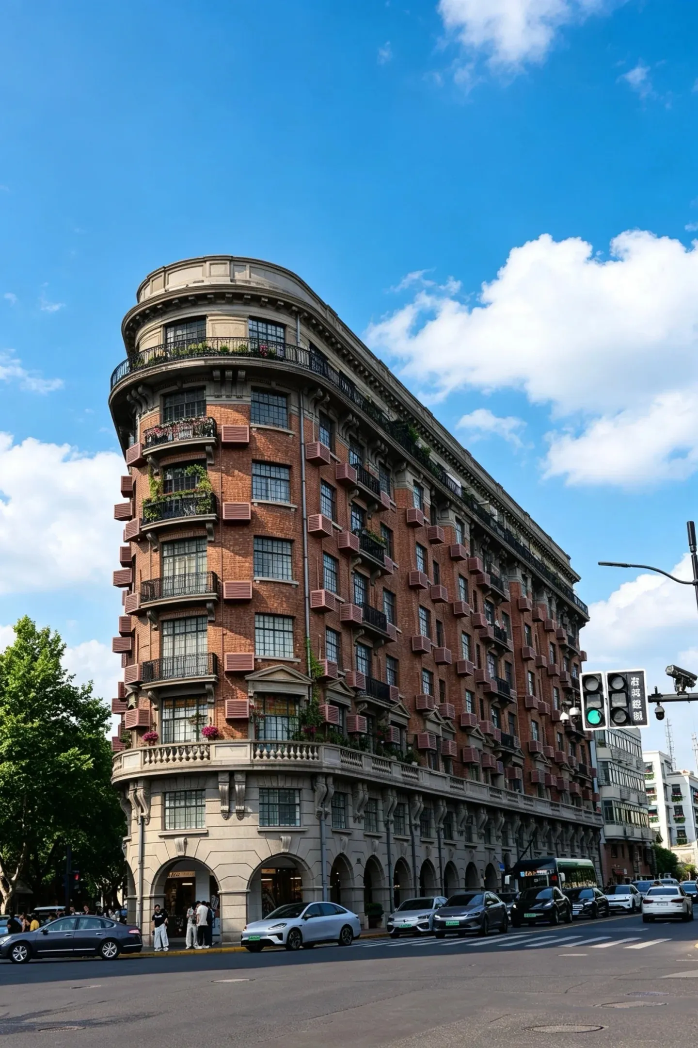 The curved red-brick corner of Wukang Mansion on a clear day, traffic passing below.